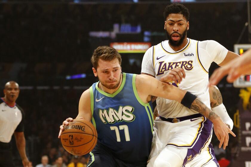 LOS ANGELES, CALIFORNIA - DECEMBER 01: Luka Doncic #77 of the Dallas Mavericks drives around Anthony Davis #3 of the Los Angeles Lakers during the first half at Staples Center on December 01, 2019 in Los Angeles, California. NOTE TO USER: User expressly acknowledges and agrees that, by downloading and or using this photograph, User is consenting to the terms and conditions of the Getty Images License Agreement. (Photo by Katharine Lotze/Getty Images)