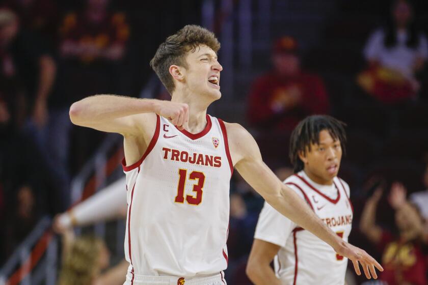 Southern California guard Drew Peterson (13) reacts after scoring against Auburn during the second half of an NCAA college basketball game Sunday, Dec. 18, 2022, in Los Angeles. Southern California won 74-71. (AP Photo/Ringo H.W. Chiu)