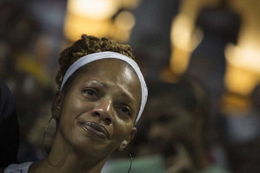 A woman reacts during a vigil for church shooting victims at TD Arena in Charleston, S.C., on Friday night.