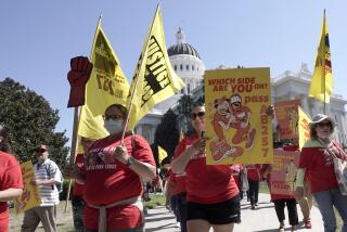 FILE - Fast food workers and their supporters march past the California state Capitol in Sacramento, Tuesday, Aug. 16, 2022. California Gov. Gavin Newsom and legislative leaders have agreed to restore funding to the Industrial Welfare Commission, which has the power to regulate wages, hours and working conditions in California. Business groups oppose restoring the commission. A law that would create a similar commission to regulate the fast food industry passed last year but has been put on hold pending the outcome of a 2024 referendum. (AP Photo/Rich Pedroncelli, File)