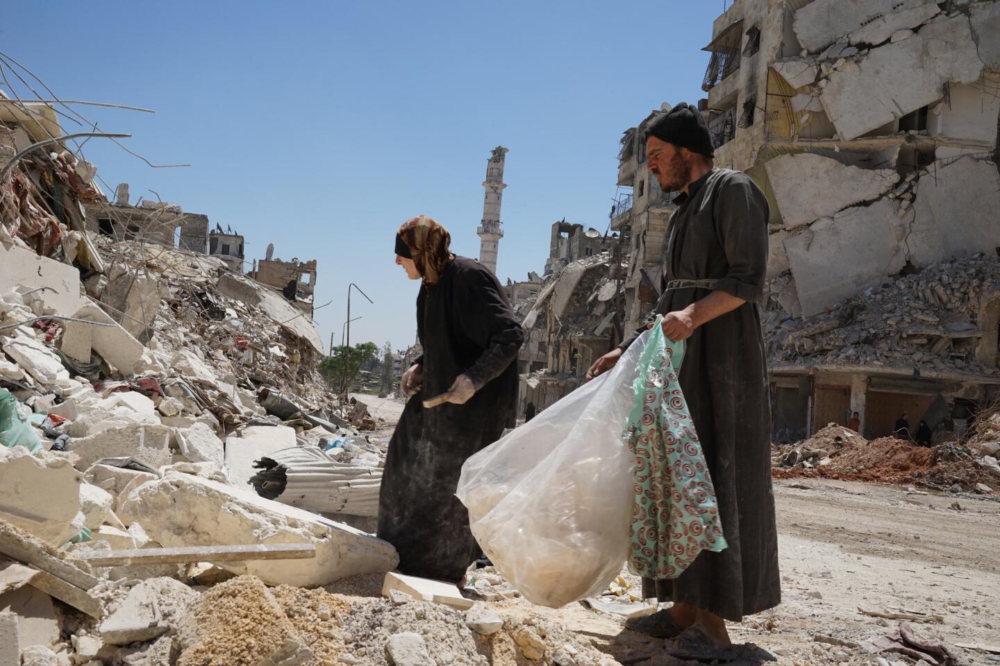 Aleppo's Salahuddin neighborhood was divided between opposition and government forces until rebels left in December. Now, many former residents are coming back to see what became of their homes. Others come to pick through the rubble.