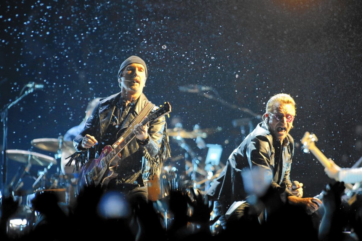 U2 guitarist The Edge, left, and lead singer Bono at the Forum on Tuesday.