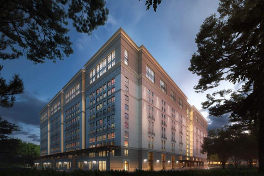 A rendering shows the exterior of the proposed Munger Hall at dusk
