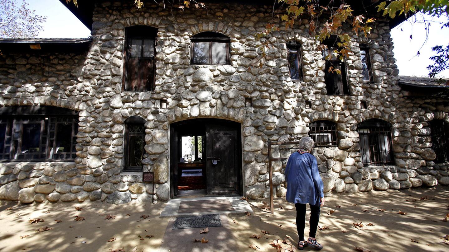 Executive Director Patricia Adler-Ingram of the Historical Society of Southern California walks outside the historic Lummis House.