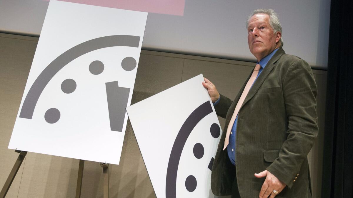 Scientist Richard Somerville unveils the Bulletin of the Atomic Scientists' updated Doomsday Clock in 2015. The clock's newest update revealed Thursday moved the clock to 11:57:30 p.m.