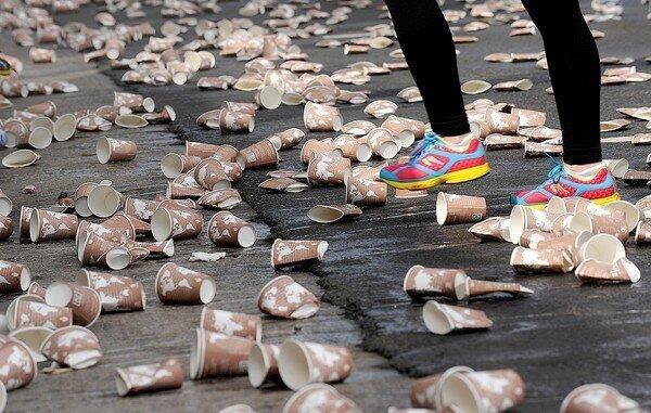 A runner passes through a sea of discarded paper cups during the 2013 L.A. Marathon.