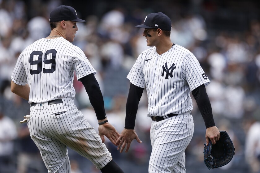New York Yankees first baseman Anthony Rizzo and designated hitter Aaron Judge (99) celebrate after the Yankees defeated the Seattle Mariners in a baseball game on Saturday, Aug. 7, 2021, in New York. The Yankees won 5-4. (AP Photo/Adam Hunger)