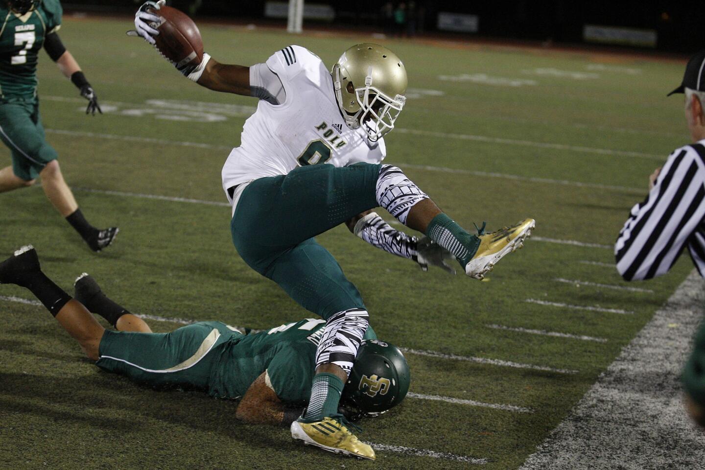 Poly receiver John Smith tries to stay inbounds after getting hit by St. Bonaventure defensive back Anthony Alamillo.