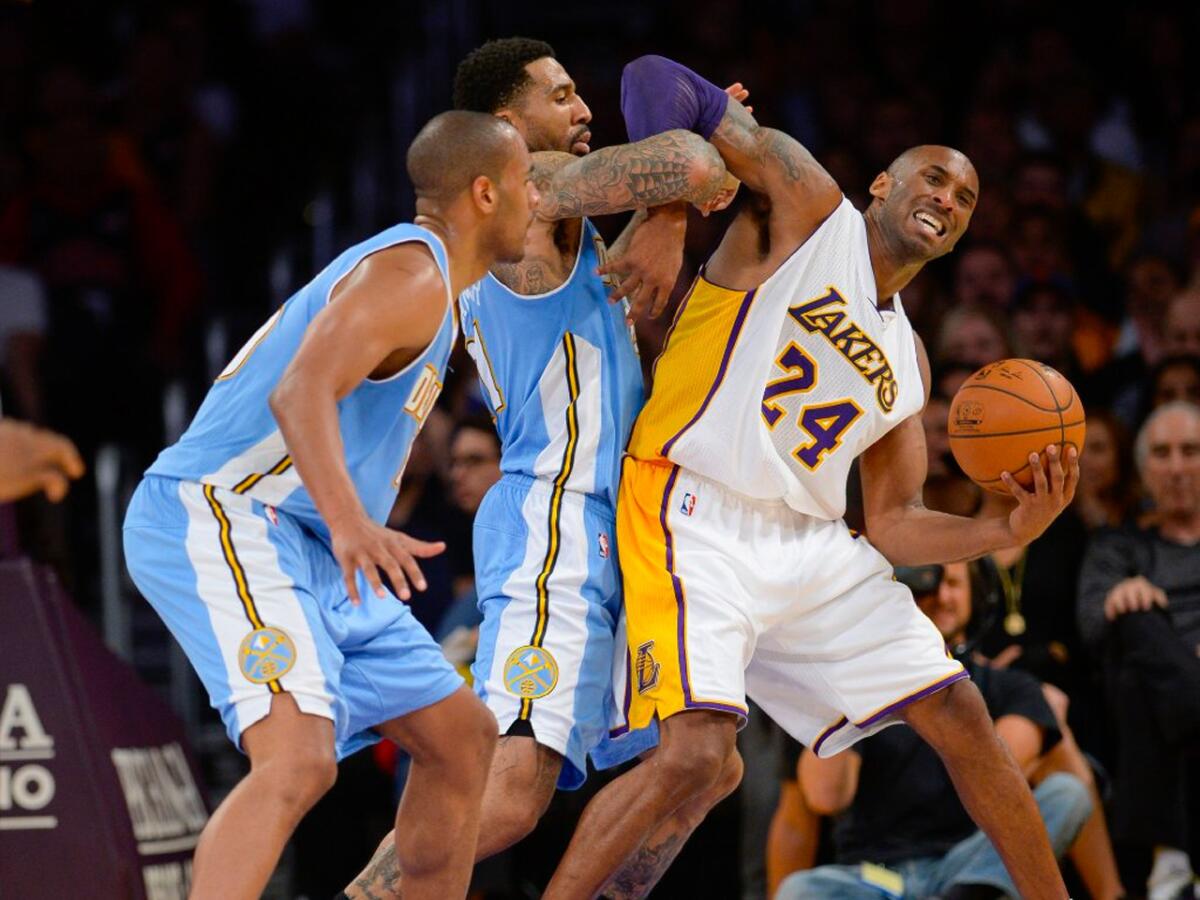 Kobe Bryant is harassed by Denver forward Wilson Chandler as guard Arron Afflalo looks on during the second half of the Lakers' 101-94 overtime loss to the Nuggets.