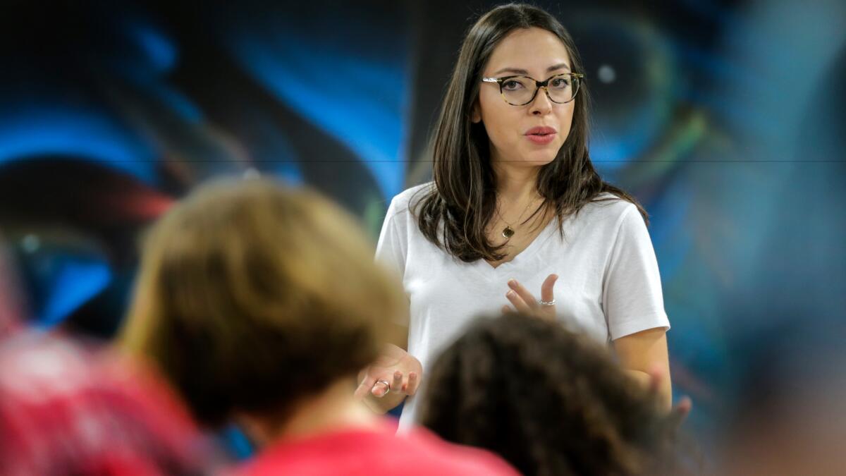 Betty Avila, associate director of Self Help Graphics, speaks to a group of kids during a workshop.
