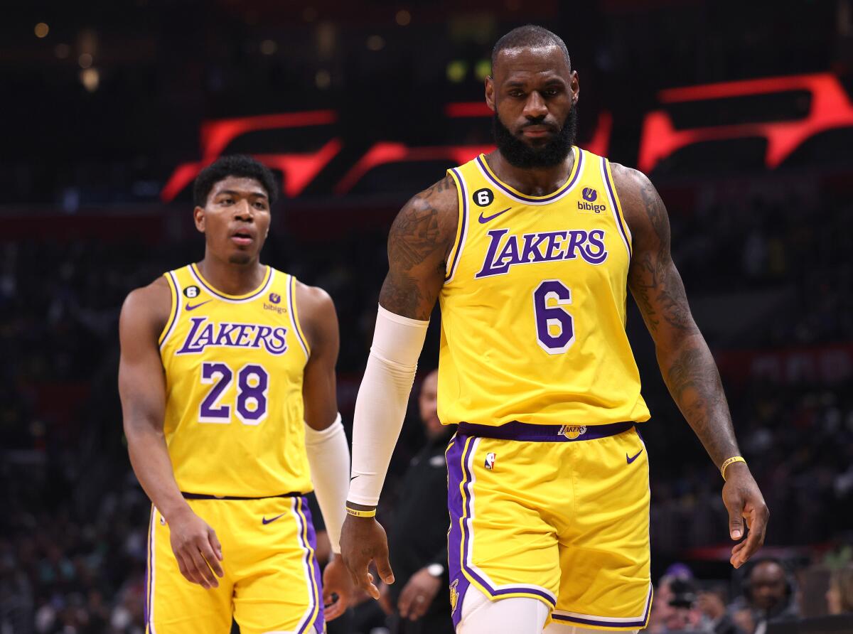 LeBron James, right, and Rui Hachimura walk on the court