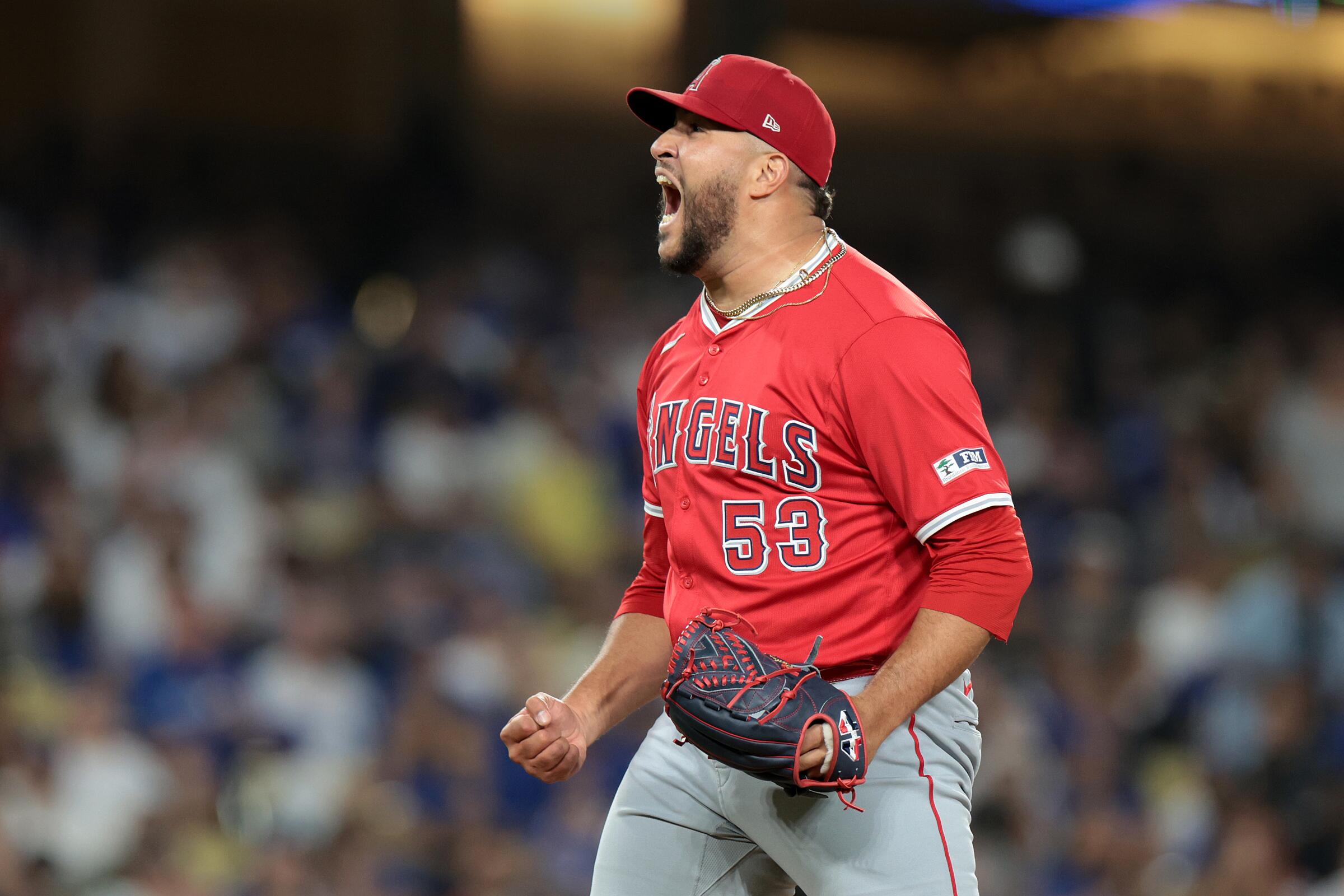 Angels closer Carlos Estévez celebrates after striking out Gavin Lux in the 10th inning.