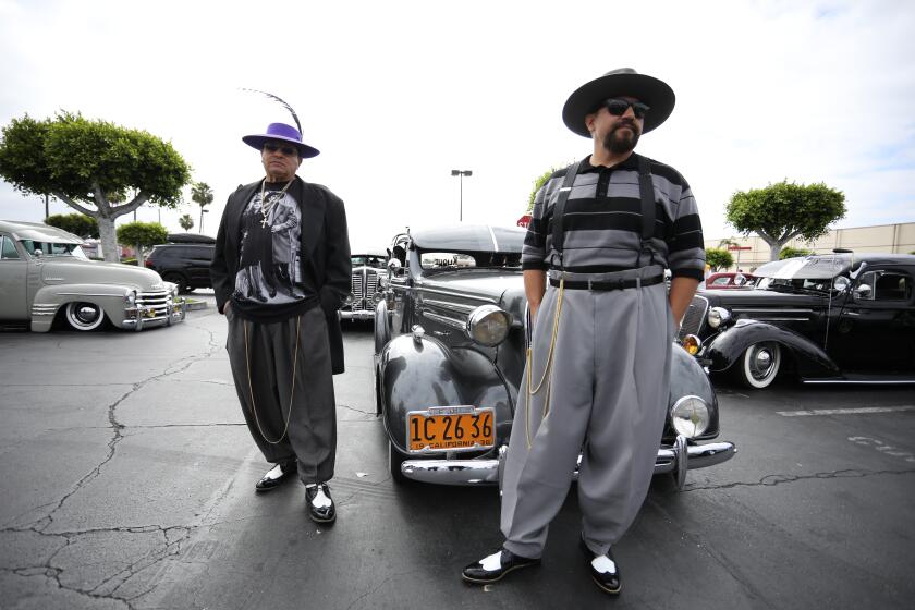 Manny Alcaraz and Art Zamora pose in the Commerce Center parking lot in East Los Angeles.