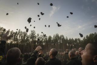 Newly recruited soldiers toss their hats as they celebrate the end of their training at a military base close to Kyiv, Ukraine, Monday, Sept. 25, 2023. As the third year of war begins, the most sensitive and urgent challenge pressing on Ukraine is whether it can muster enough new soldiers to repel – and eventually drive out – an enemy with far more fighters at its disposal. (AP Photo/Efrem Lukatsky)