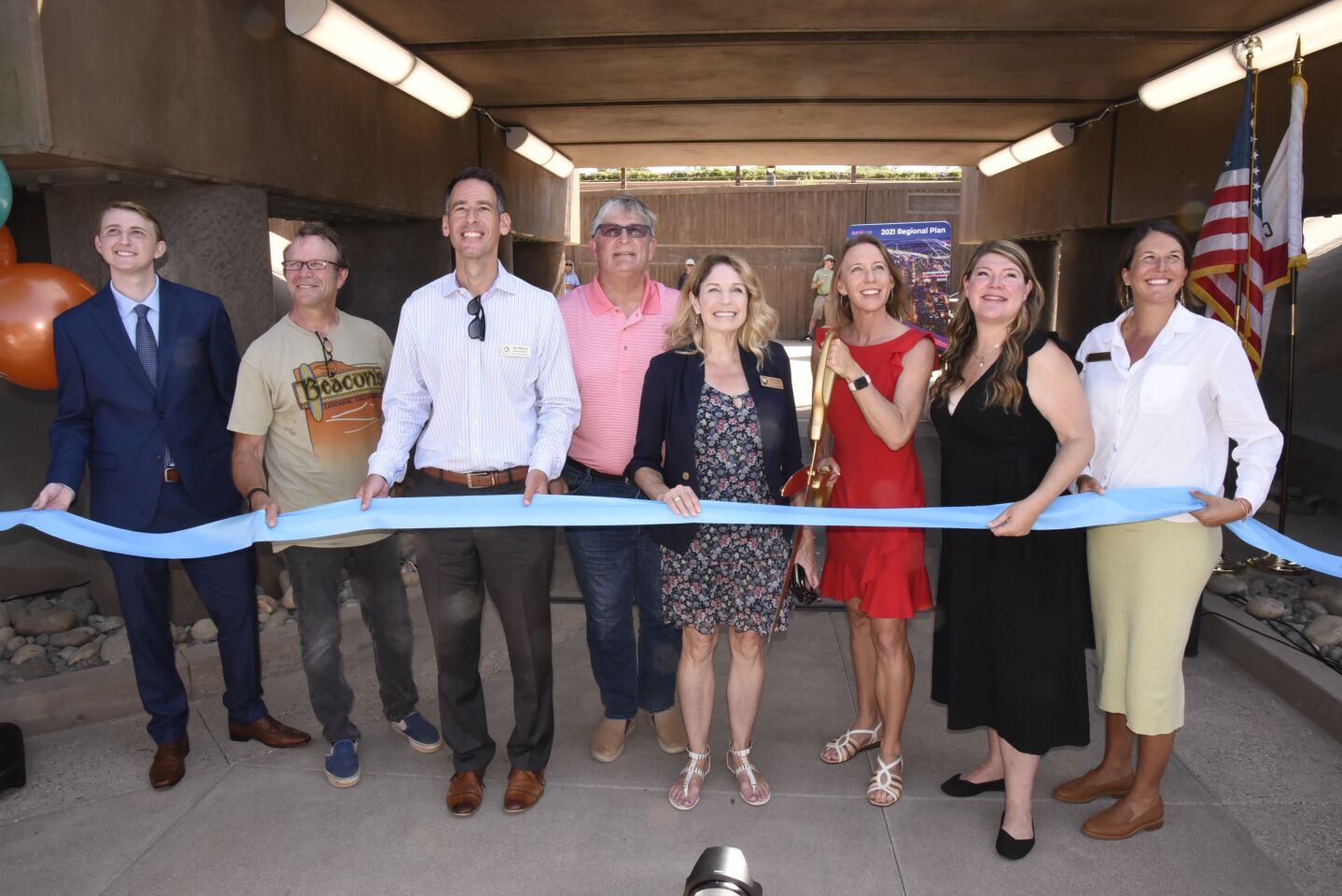 SANDAG Chair/Encinitas Mayor Catherine Blakespear cuts the ribbon to officially open the El Portal Street undercrossing as council members and dignitaries look on