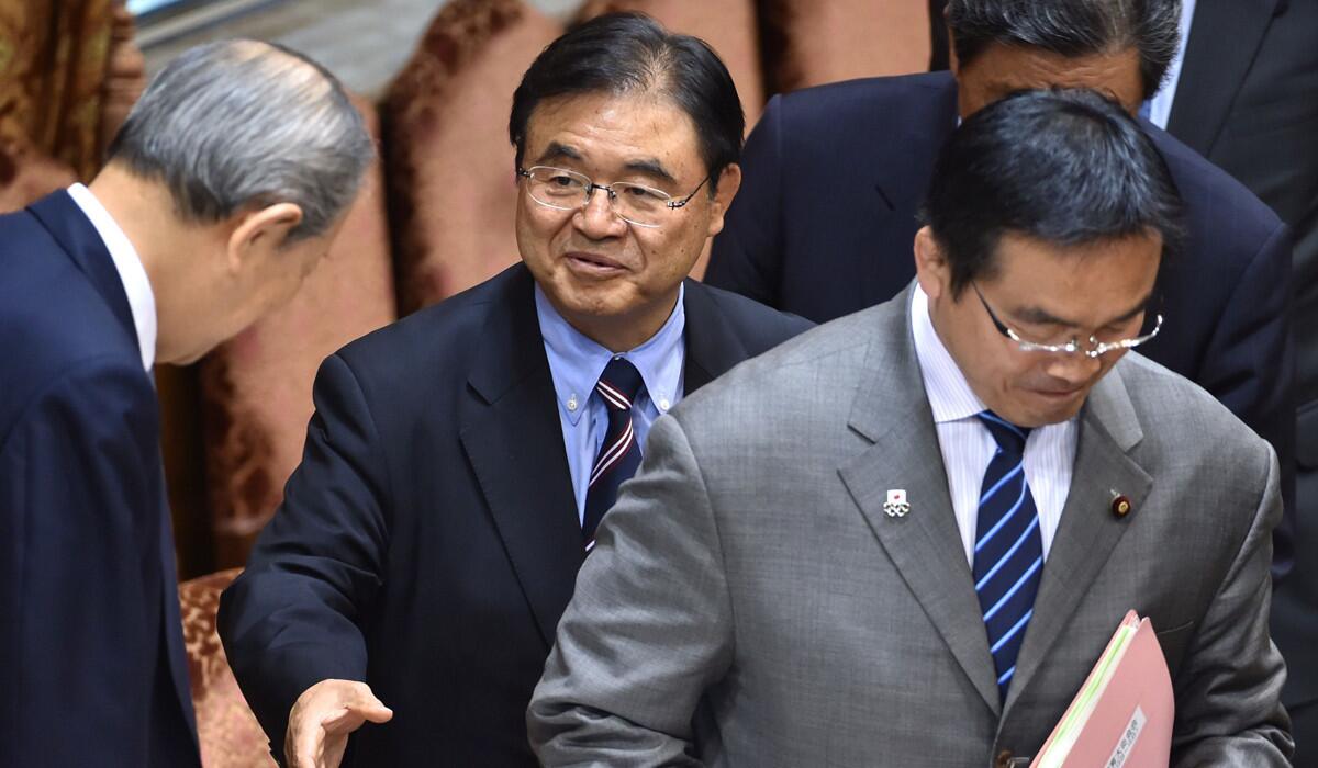 Japan's Olympics minister, Toshiaki Endo, center, leaves a budget committee session of the House of Councillors in Tokyo on Friday. Japan said it would question officials involved in Tokyo's successful 2020 Olympics bid over a multimillion-dollar payment that is being probed by French investigators.