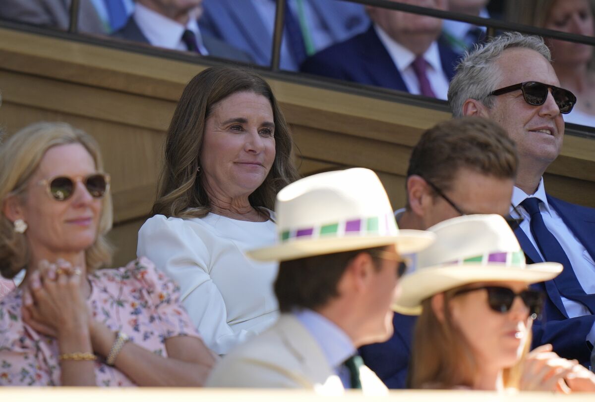 Melinda French Gates, center, sits in the Royal Box on Centre Court to watch Serbia's Novak Djokovic and Britain's Cameron Norrie in a men's singles semifinal on day twelve of the Wimbledon tennis championships in London, Friday, July 8, 2022. (AP Photo/Alastair Grant)
