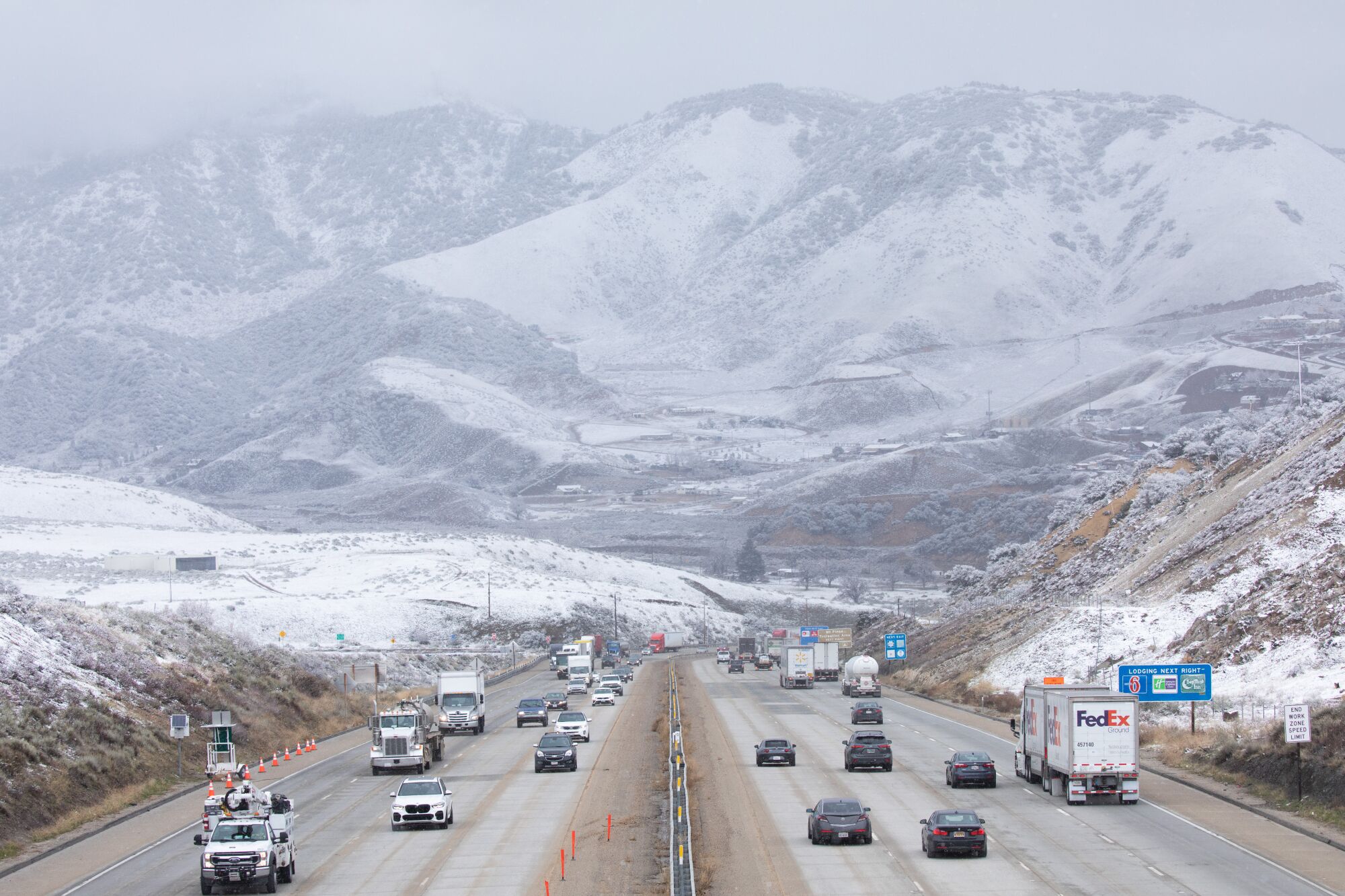 Traffic on the 5 Freeway rolls through a snowy landscape in Lebec on Jan. 30.