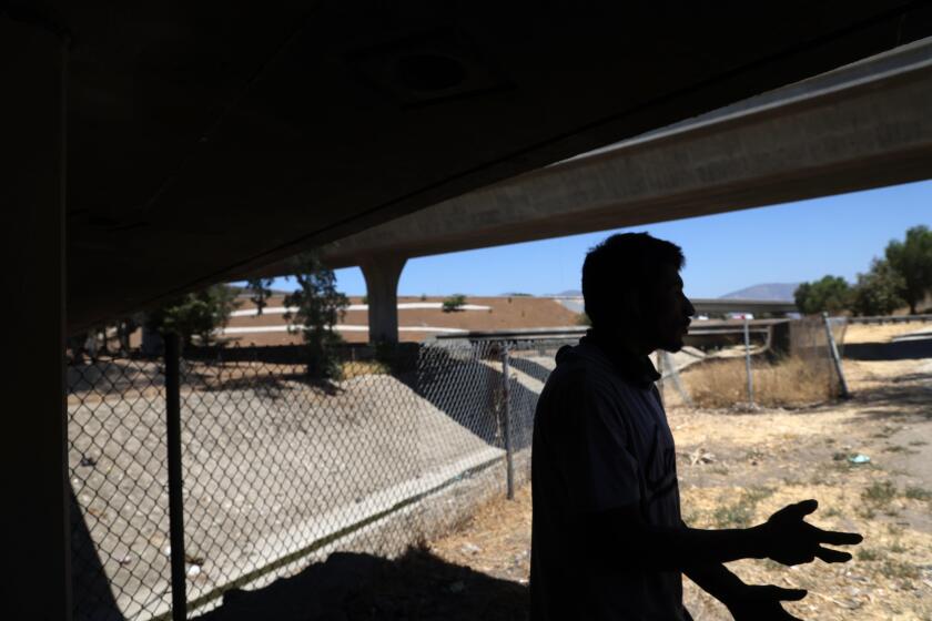 PACOIMA, CA - AUGUST 16, 2024 - Luis Tortes, 28, talks about his past year and a half of living homeless underneath State Route II8 in Pacoima on August 16, 2024. Gov. Gavin Newsom and Caltrans workers cleaned up homeless encampments a few blocks away along Paxton Street and Remick Avenue on August 8, 2024. The homeless didn't return to area of the clean-up, but many were living in encampments under the nearby San Fernando Valley freeways. Gov. Gavin Newsom threatened on Thursday, August 8, to take away state funding from counties that don't show improvement on homelessness. (Genaro Molina/Los Angeles Times)