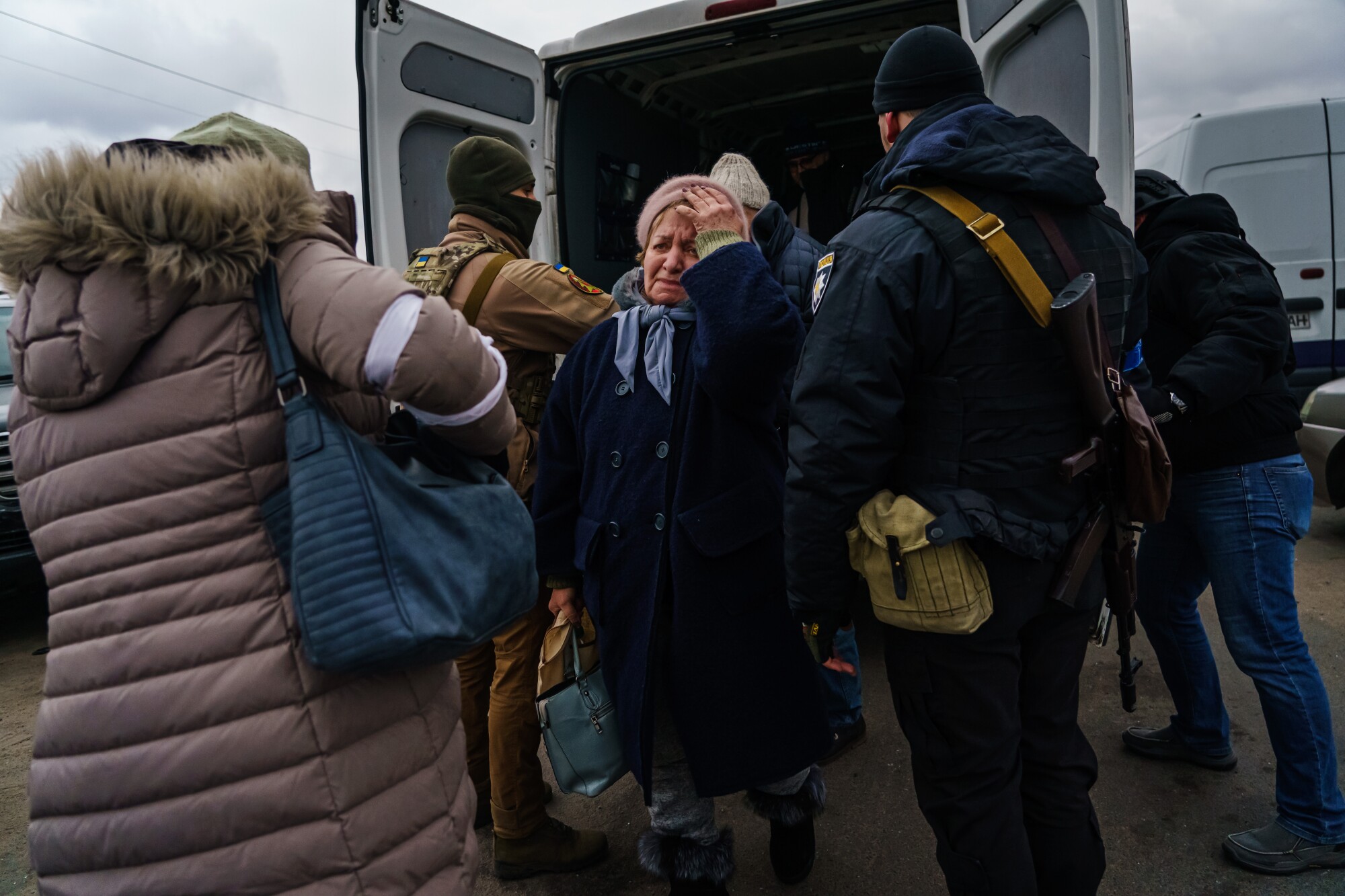 Ukrainian volunteers seek to save the living outside Kyiv - Los Angeles Times 5 People gathered outside a van