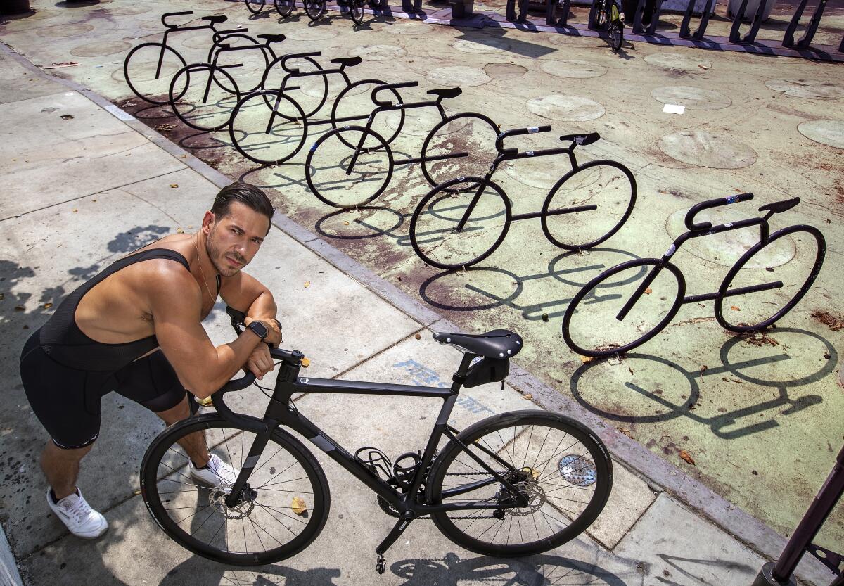 Seth Gottesdiener poses with bicycles.