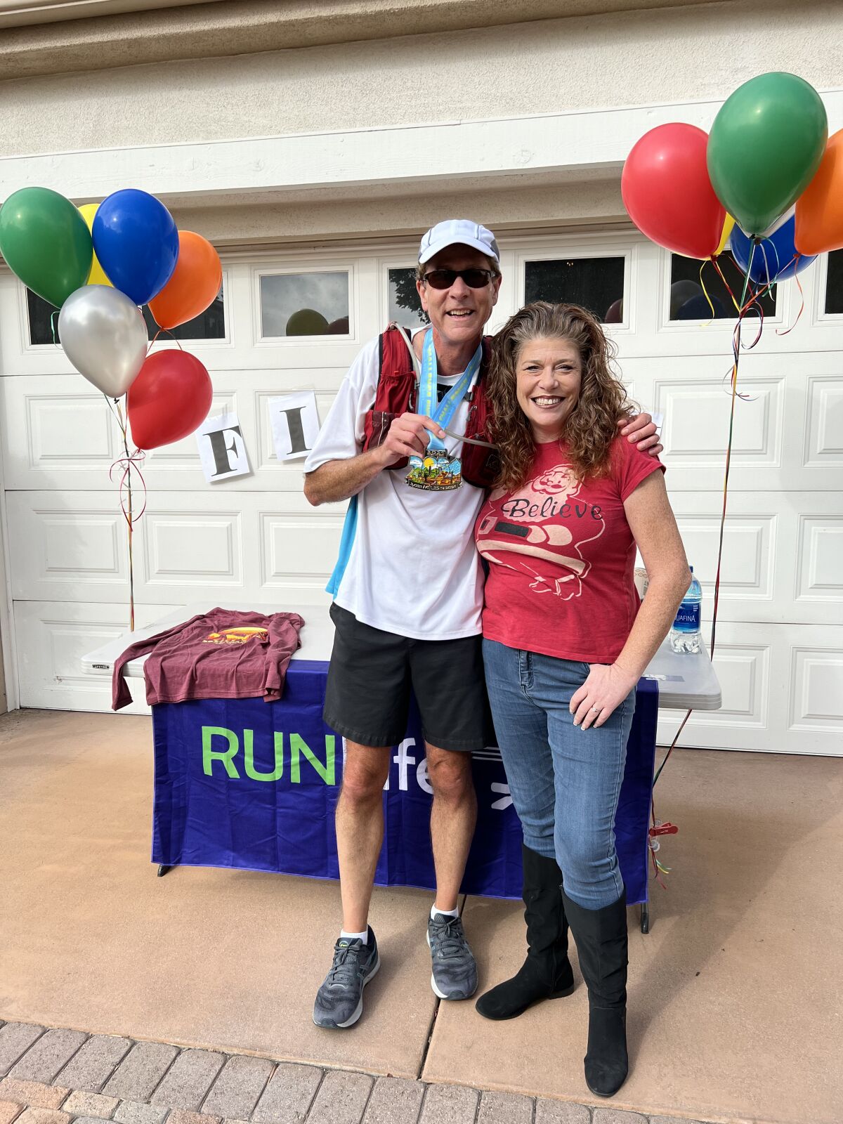 Sean Curry celebrates 2,021 miles with his wife Joice.