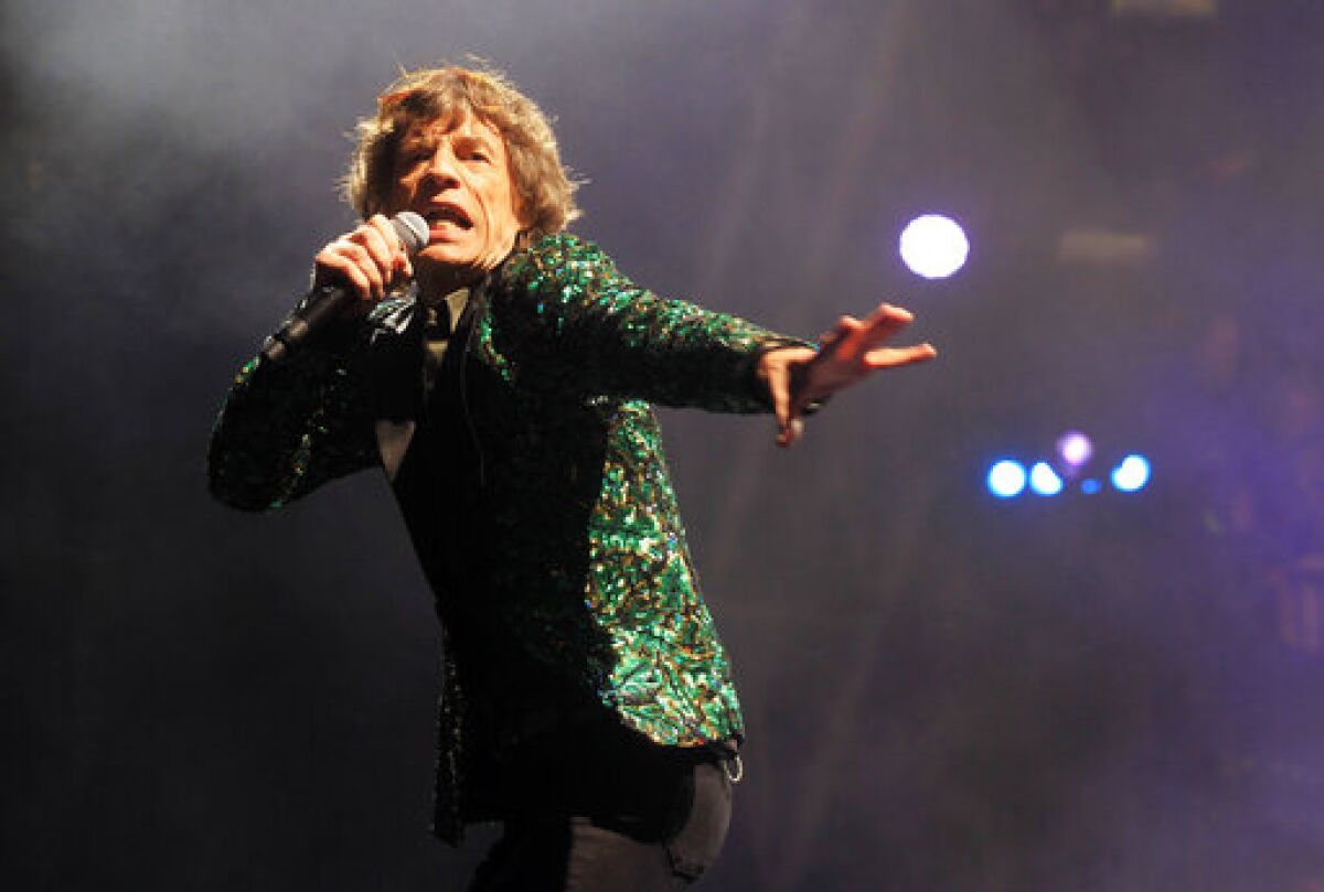FILE - Mick Jagger of The Rolling Stones performs in Glastonbury, England on June 29, 2013. Jagger's jacket is among 55 L'Wren Scott creations going on sale this week at Christie’s in London. (Photo by Jim Ross/Invision/AP, File)