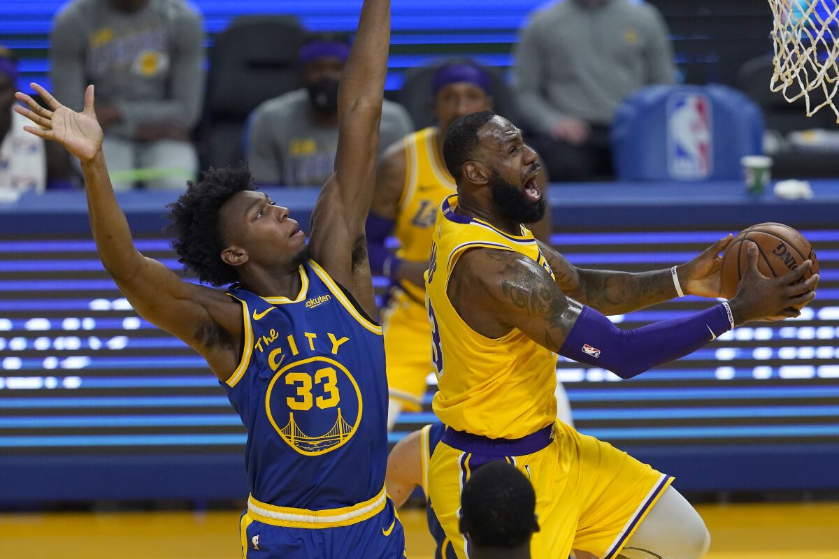 Lakers forward LeBron James shoots against Golden State Warriors center James Wiseman.