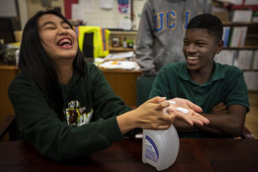 LOS ANGELES, CALIF. - MARCH 03: Bless Patawaran, 13, left, and Cody Holmes, 13, right, are student leaders at Burroughs Middle School in Los Angeles, Calif. on Tuesday, March 3, 2020. The student leaders here are making a PSA video for the school instucting the proper hand washing technique. The workers are being veginate cleaning the school for the health and safety of the students and staff currently because of the COVID-19 otherwise known as the coronavirus. (Francine Orr / Los Angeles Times)