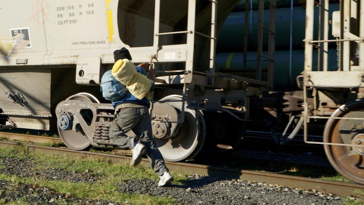 Besser Geovanny Zelaya Ortiz shows his brother and a friend how to run for a train more safely.