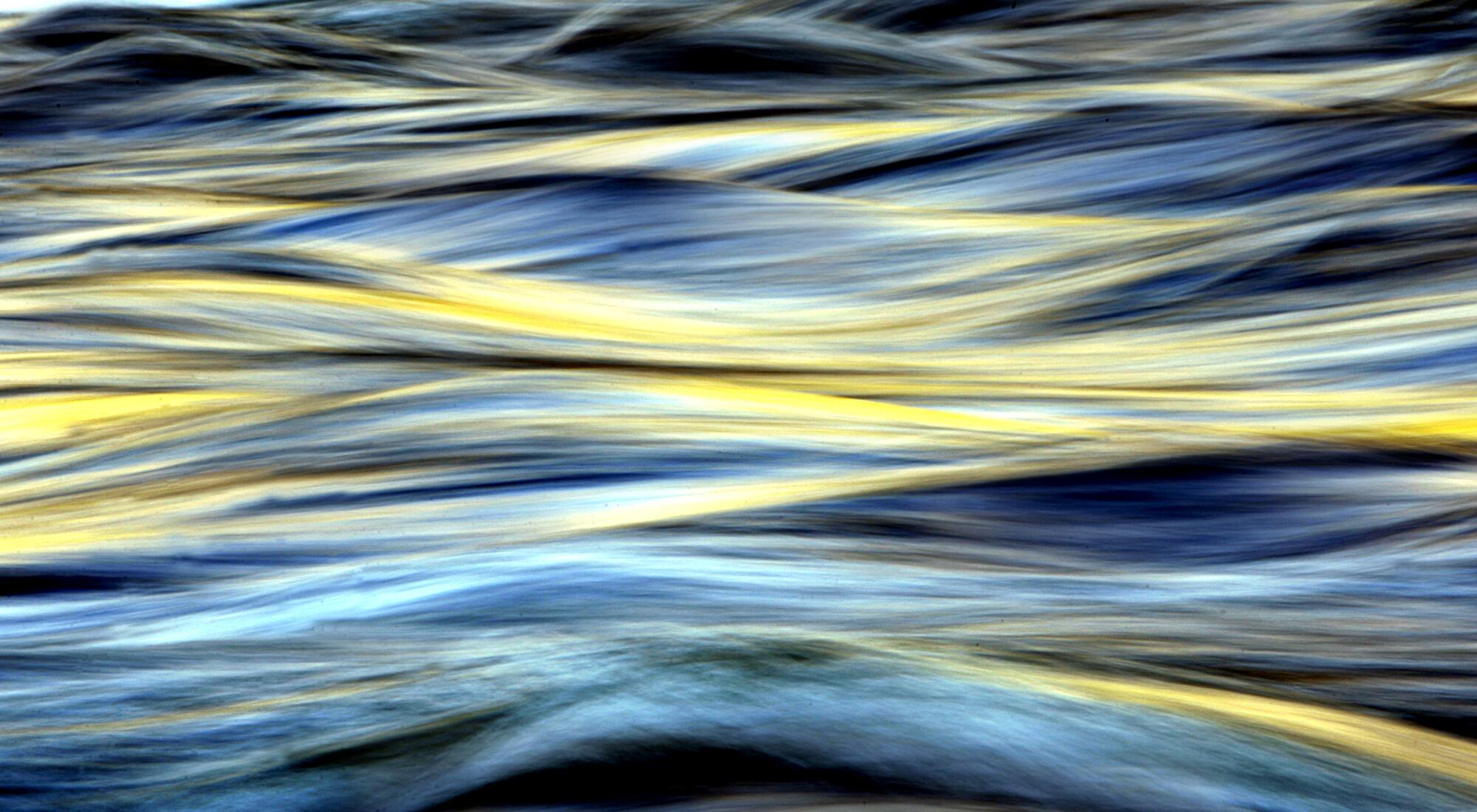 Water flowing, seen in blues and yellows