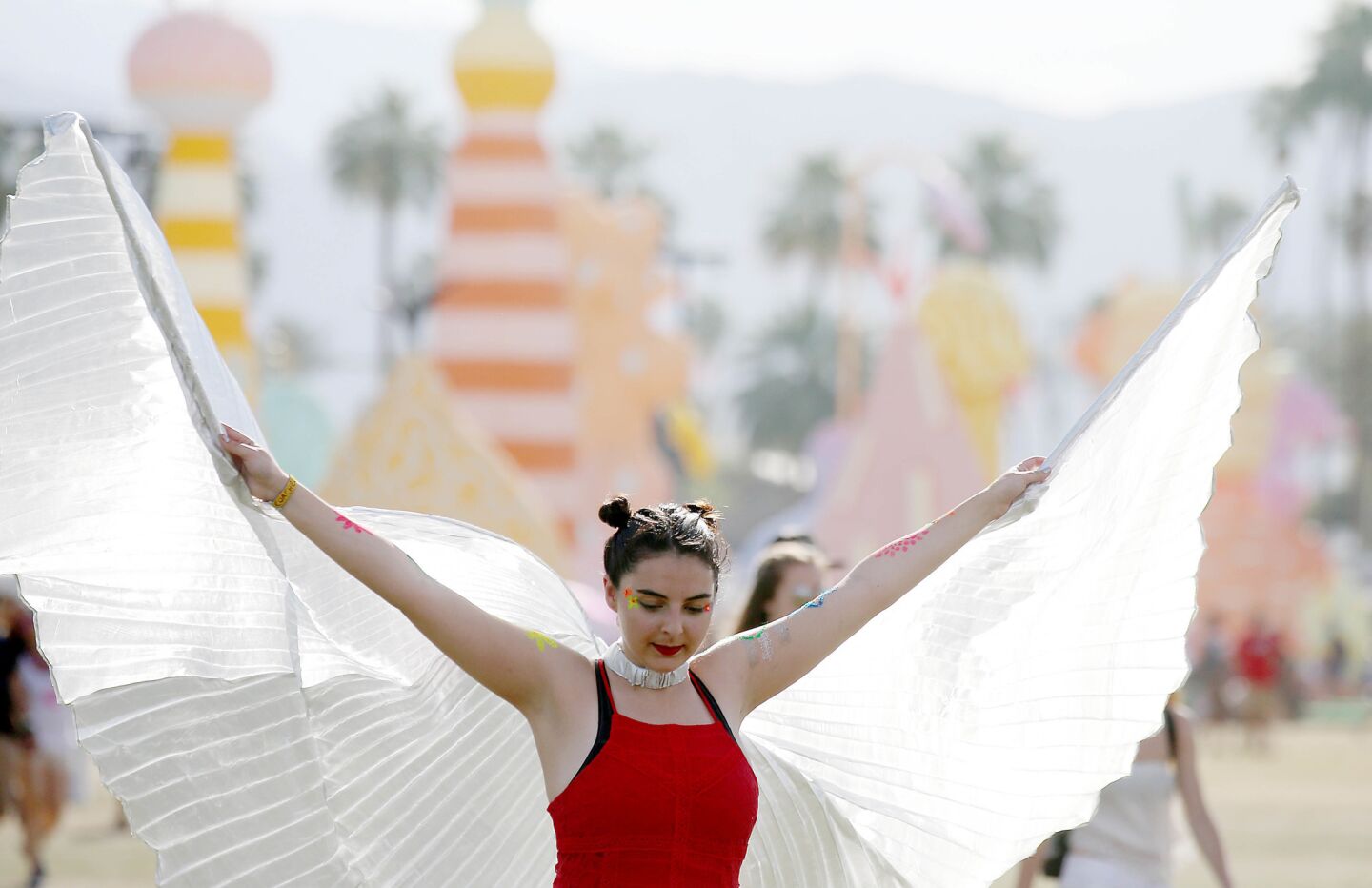 INDIO, CALIF. - APRIL 16, 2017. Britt Jacobson, 18, spreads her wings on day three of the Coachella Music and Arts Festival in Indio on Sunday, April 16, 2017. (Luis Sinco/Los Angeles Times)