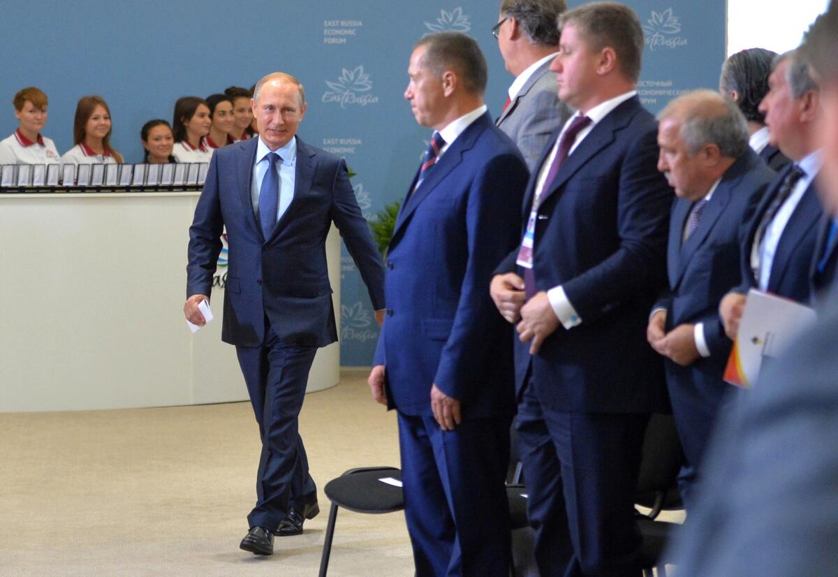 Russian President Vladimir Putin, left, arrives at the opening of the East Economic Forum in Vladivostok on Sept. 4, where he pressed his diplomatic initiative to end Syria's civil war.