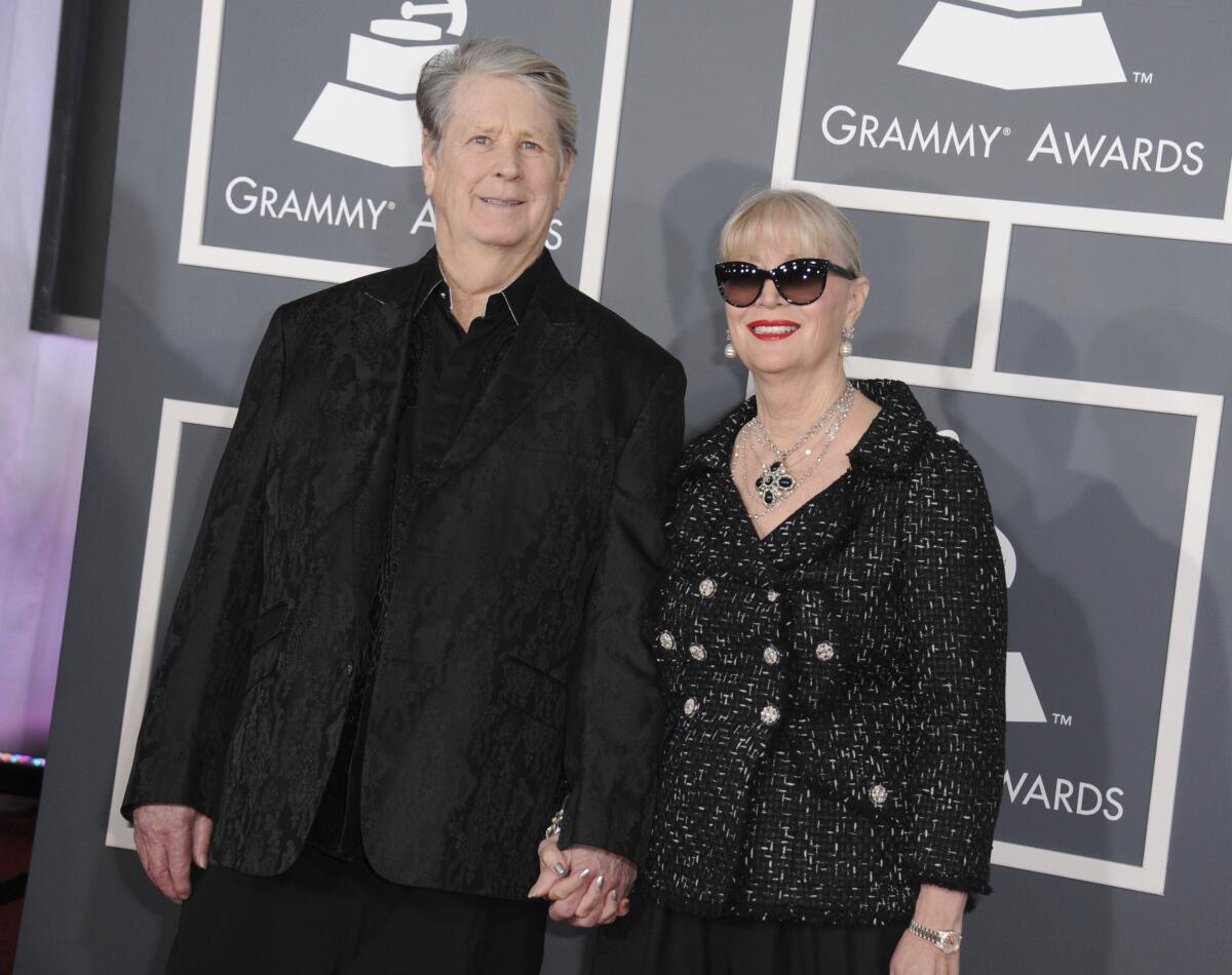 Brian Wilson arriving at the 2013 Grammys wearing black and holding hands with wife Melinda.