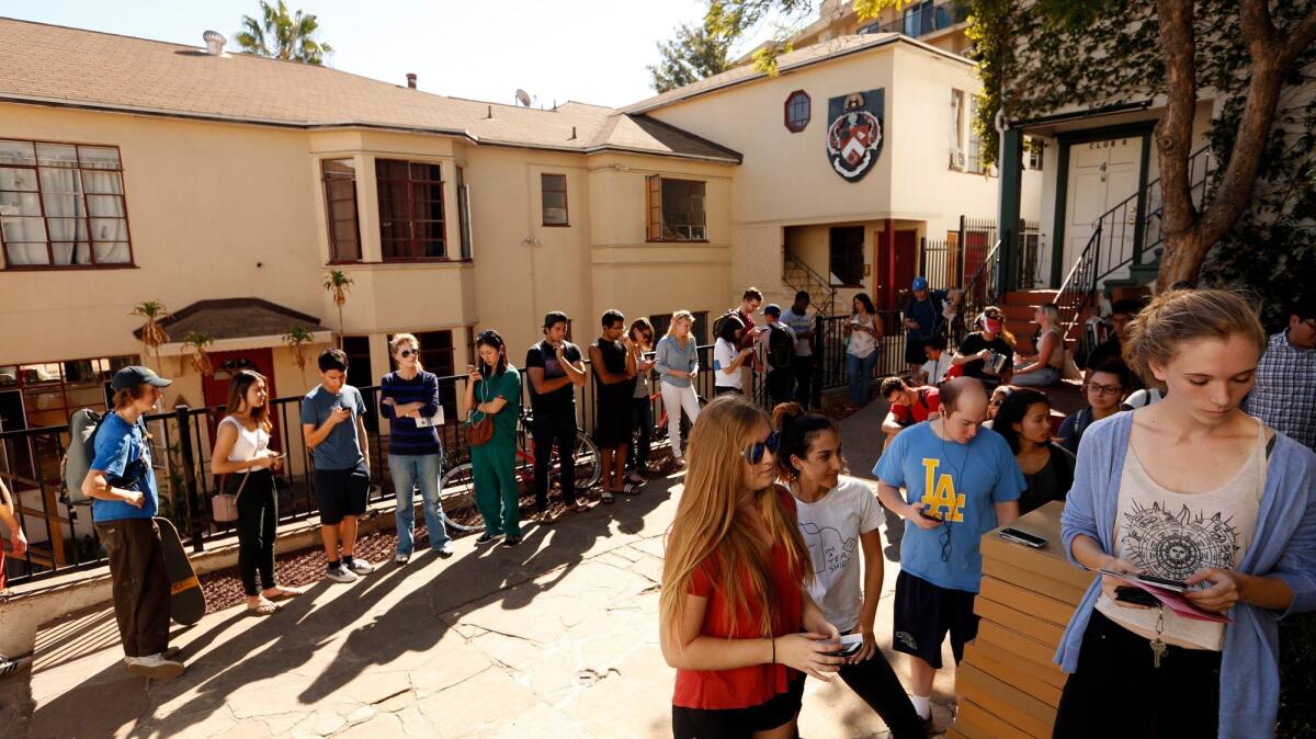 UCLA students wait in line to cast their votes at the Alpha Gamma Omega Fraternity House in Westwood.