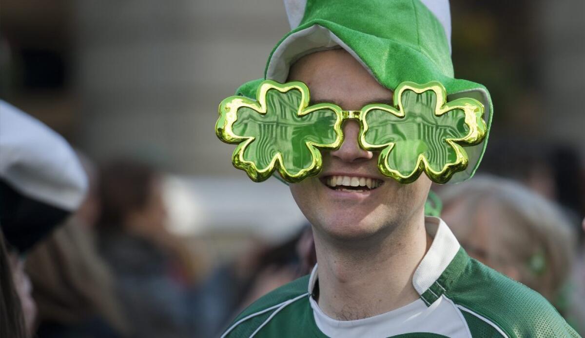 A man wearing clover-shaped glasses attends the St. Patrick's Day parade in central London on Sunday.