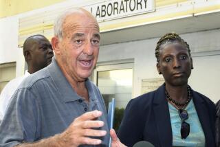 FILE - Pathologist Dr. Cyril Wecht, center, talks to the media while Bahamas' head coroner Linda Virgil, right, and attorney Michael Scott, left, listen outside the Rand Laboratory morgue at the Princess Margaret Hospital in Nassau, Bahamas, Sept. 17, 2006. Wecht, a pathologist and attorney whose biting cynicism and controversial positions on high-profile deaths such as President John F. Kennedy’s 1963 assassination caught the attention of prosecutors and TV viewers alike, died Monday, May 13, 2024. He was 93. (AP Photo/Tim Aylen, File)