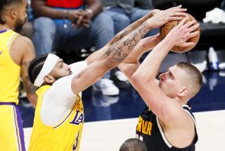 DENVER, CO - MAY 18: Los Angeles Lakers forward Anthony Davis, left, tries to cover the shot of Denver Nuggets.
