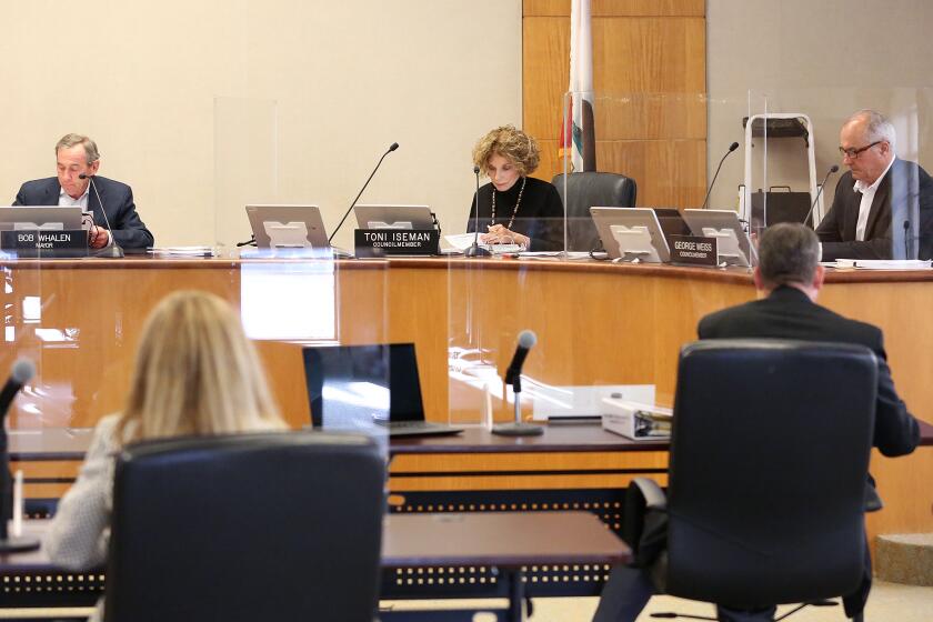 Laguna Beach City Council members Sue Kempf, mayor Bob Whalen, Toni Iseman, and George Weiss, begin Tuesday's in-chambers meeting, the first since the city council has been on the dais together since the modifications and closures were made due to the coronavirus pandemic.