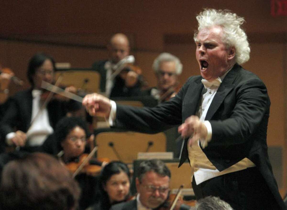 Simon Rattle conducts the Los Angeles Philharmonic at Walt Disney Concert Hall in 2012. The conductor announced he will be leaving his post as artistic director of the Berlin Philharmonic in 2018.