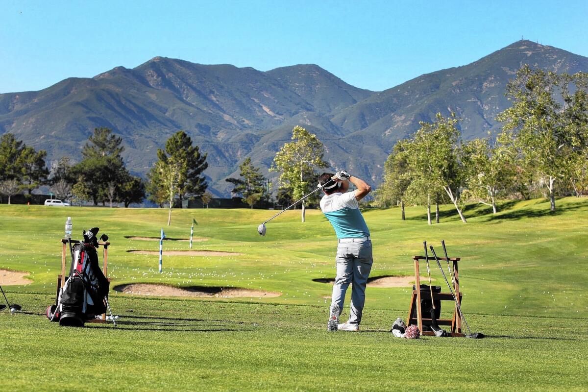 Brent Meschuk practices his swing at the driving range overlooking Saddleback Mountain at the Dove Canyon Golf Club.