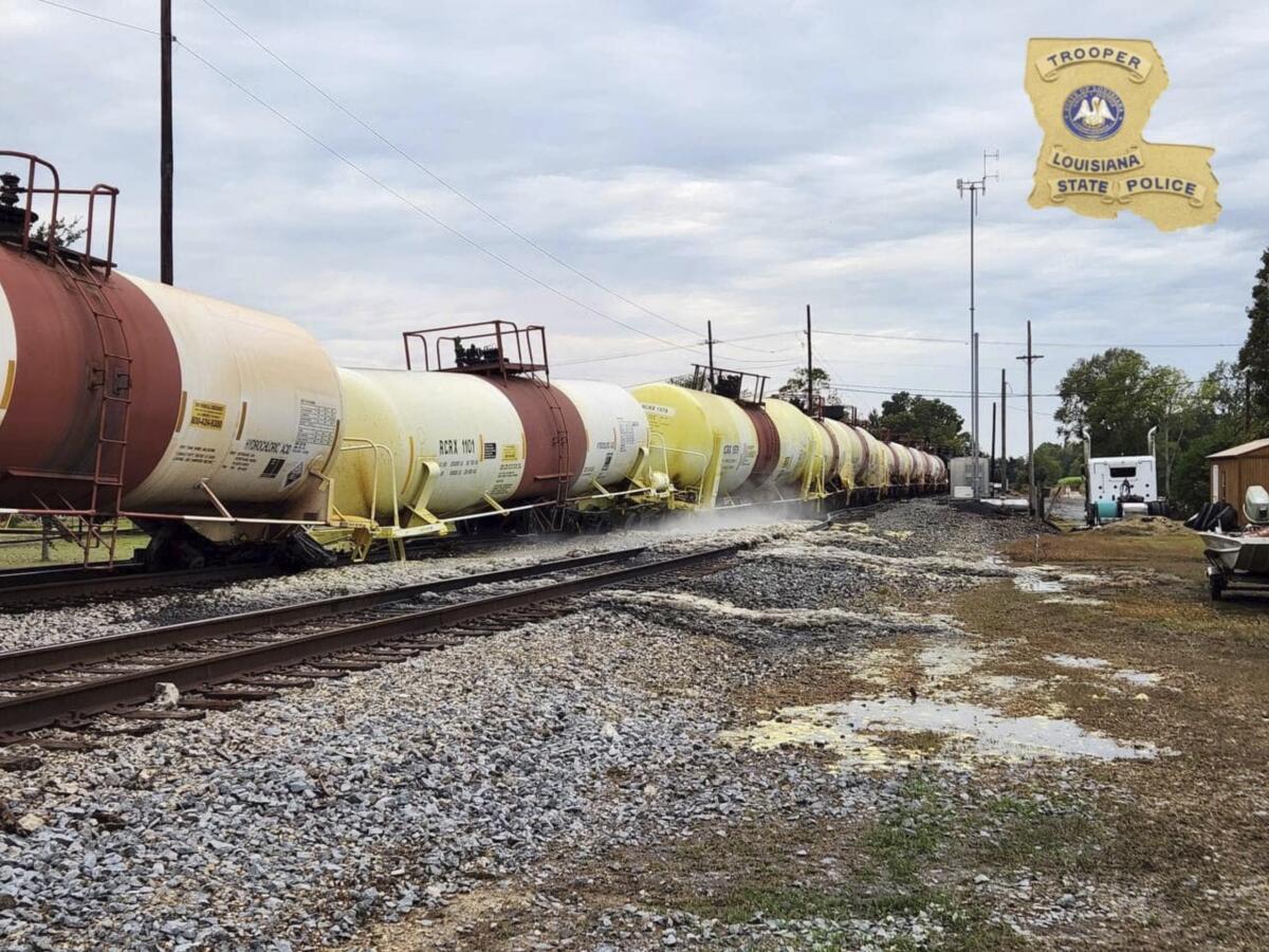This photo provided by Louisiana State Police shows a railcar leaking hydrochloric acid in St. James Parish, La., on Wednesday, Nov. 2, 2022, according to the police. The derailment of six train cars and a subsequent acid leak prompted road closures and evacuations Wednesday in a Louisiana community, officials said. (Louisiana State Police via AP)