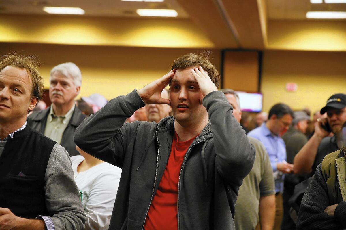 A voter reacts to Iowa caucus returns at a Donald Trump campaign watch party Monday in Des Moines.
