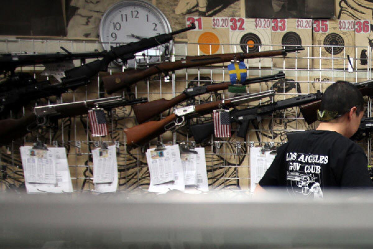 A clerk in the Los Angeles Gun Club helps customers in 2013.
