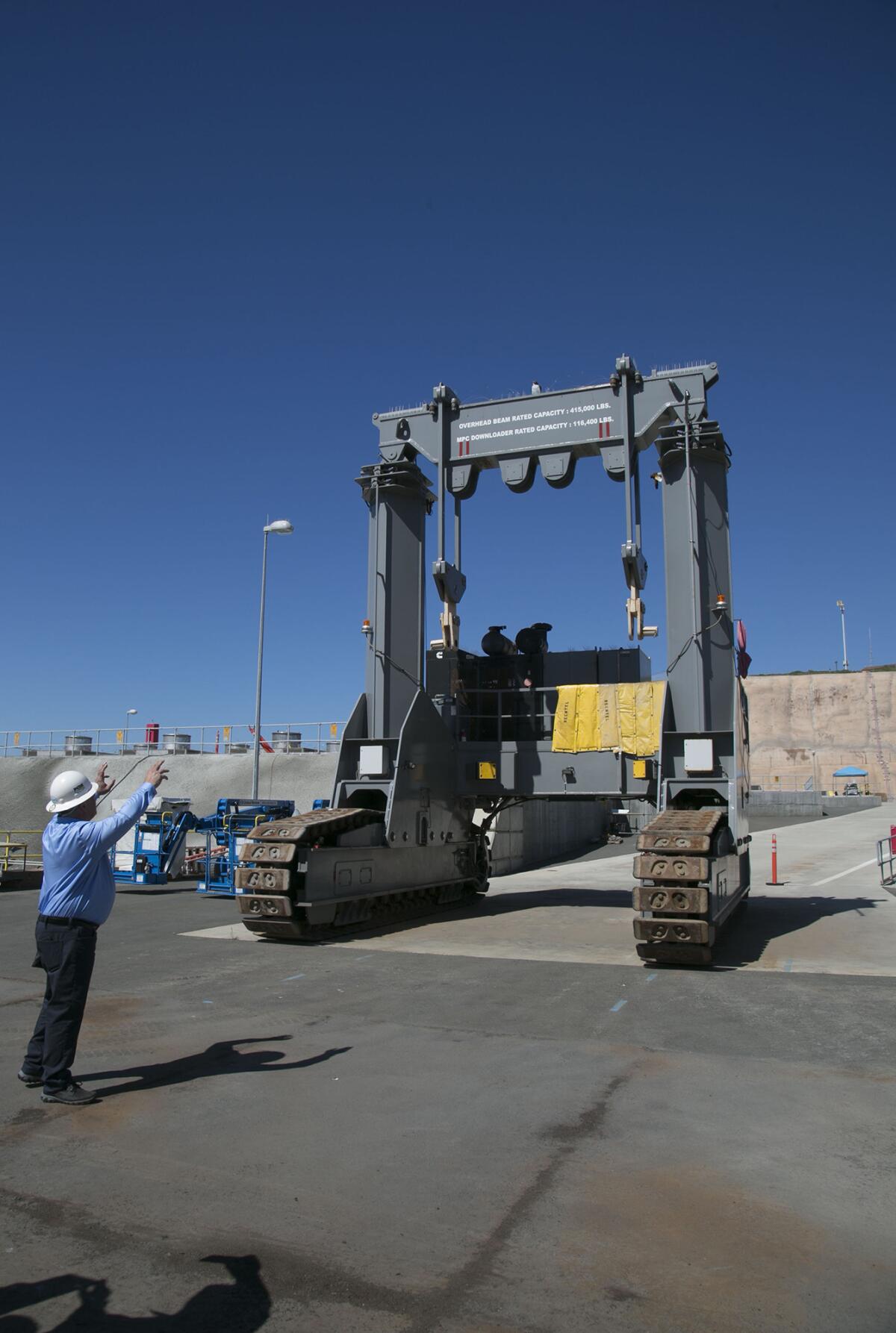 Jim Peattie, General Manager for Decommissioning Oversight, demonstrates in March 2019 how this specialized crane is used to lower the canisters holding spent nuclear fuel into underground cavities at a newly constructed storage facility at the now-shuttered San Onofre Nuclear Generating Station.