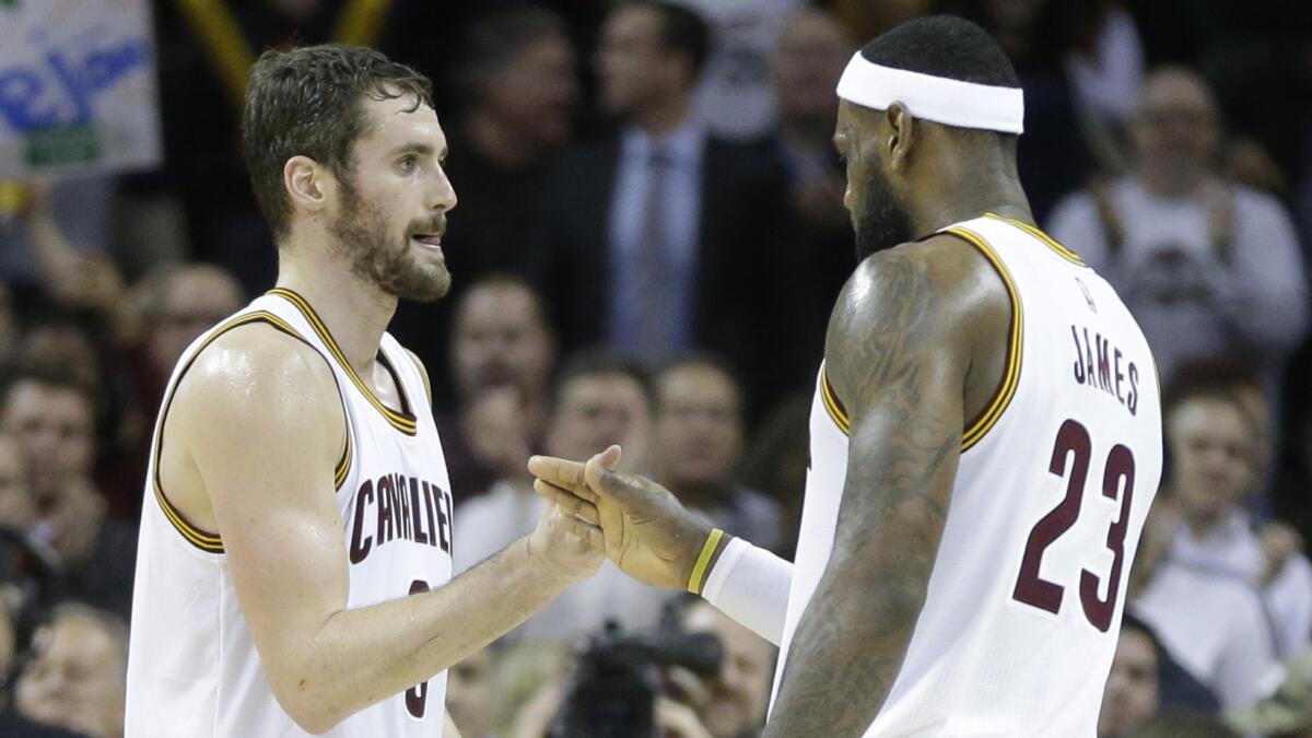 Cleveland Cavaliers teammates Kevin Love, left, and LeBron James celebrate a 97-88 win over the Charlotte Hornets on Monday.