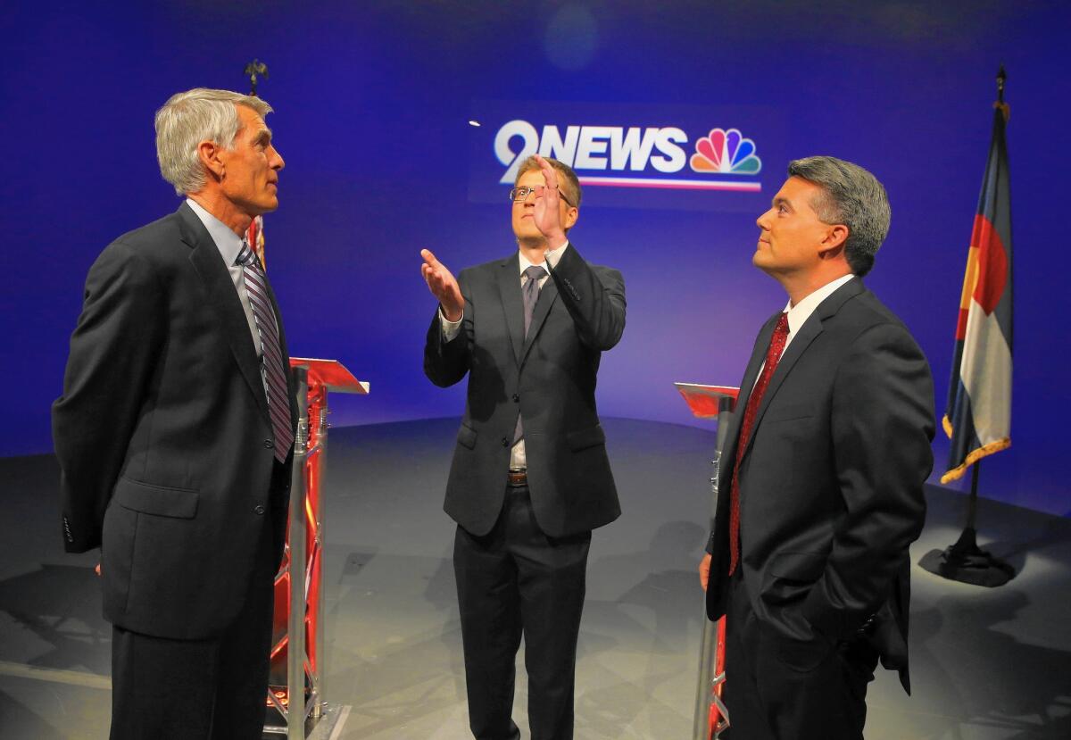 Total spending in midterm races is projected to top $4 billion nationwide, making it the most expensive midterm election in history. Above, Democratic Sen. Mark Udall and GOP Rep. Cory Gardner, right, candidates in Colorado's Senate contest, watch a coin flip by a debate moderator on Oct 15.
