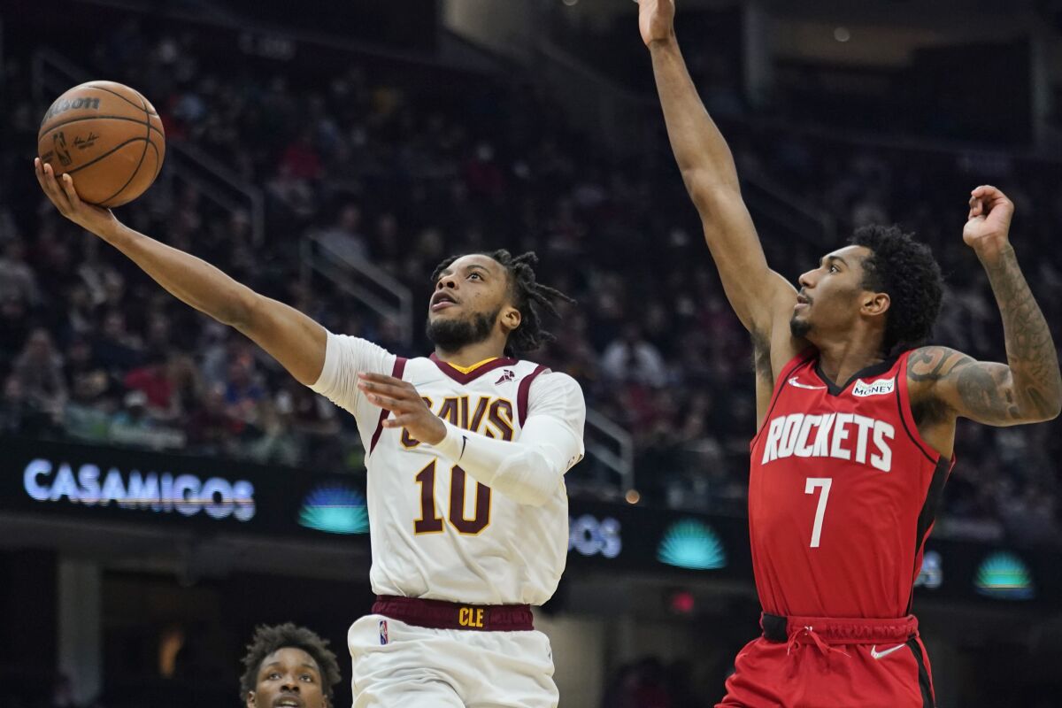 Cleveland Cavaliers' Darius Garland (10) drives to the basket against Houston Rockets' Armoni Brooks (7) in the first half of an NBA basketball game, Wednesday, Dec. 15, 2021, in Cleveland. (AP Photo/Tony Dejak)