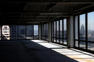 City Hall is framed by windows at an office space at One Wilshire in downtown Los Angeles.