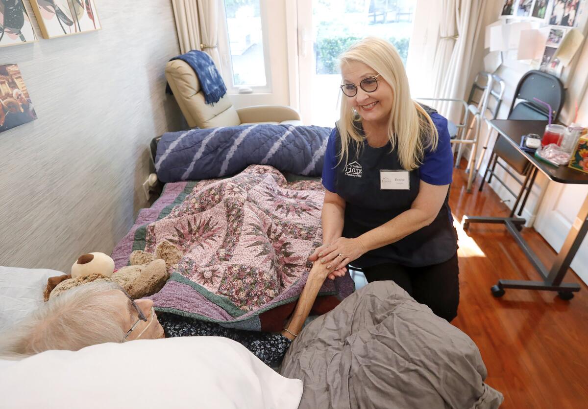 Caregiver Denise Hyde chats with resident June Malchow, at the Heavenly Home in Mission Viejo Tuesday.